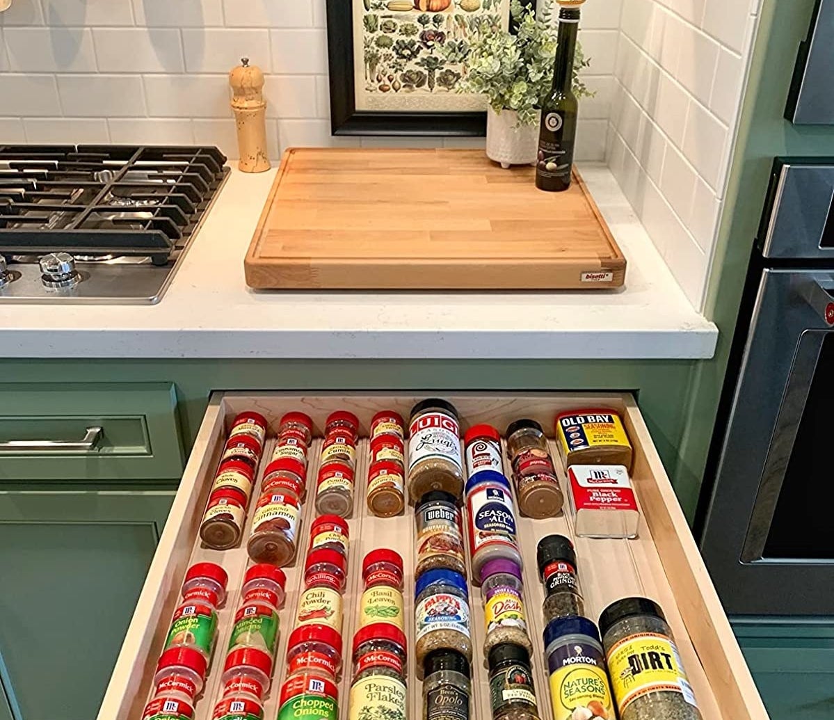 Reviewer&#x27;s photo of a spice drawer organized using the spice drawer organizer