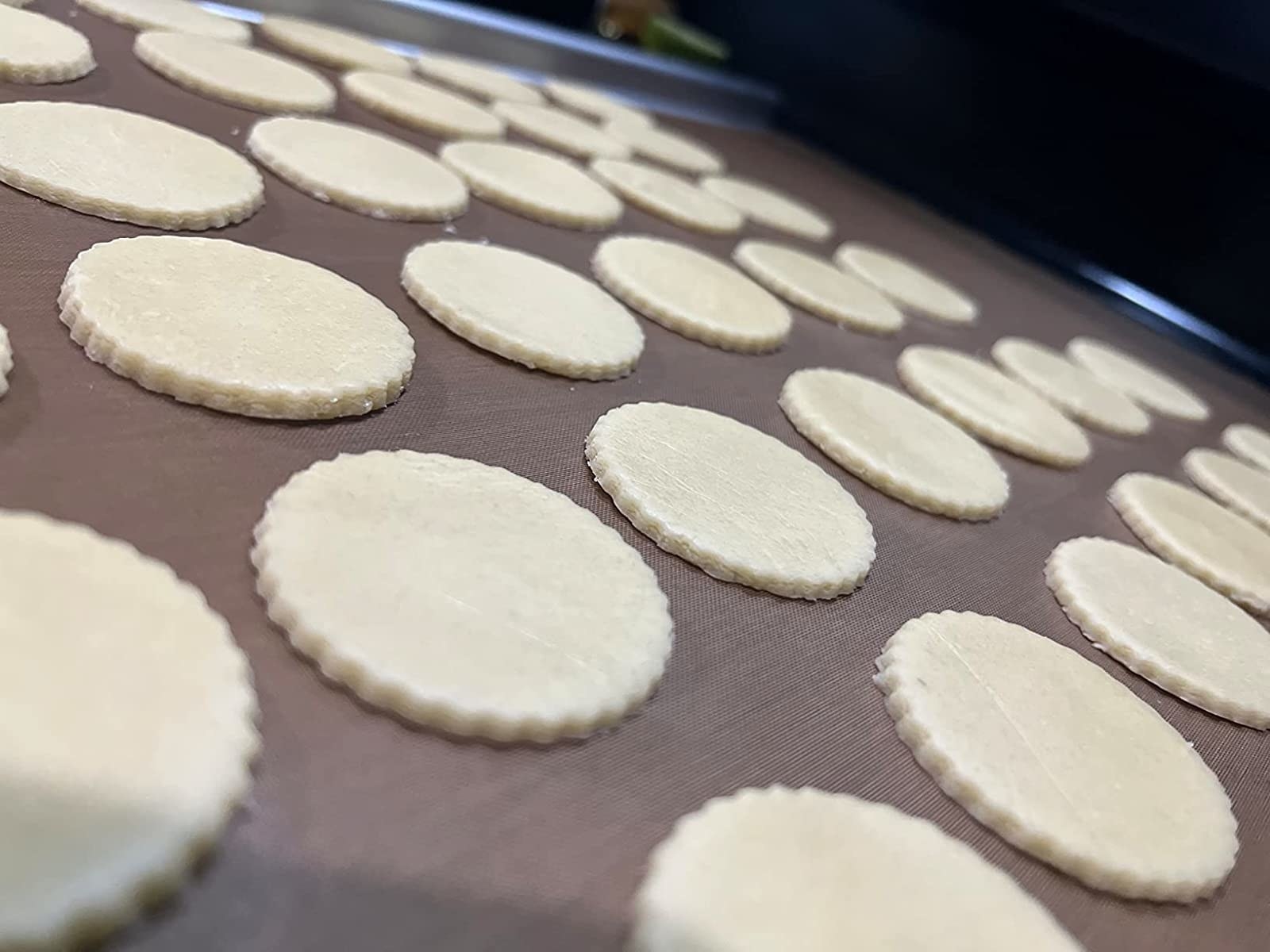 Reviewer&#x27;s photo of perfectly even cookies rolled out using the rolling pin, waiting to be baked