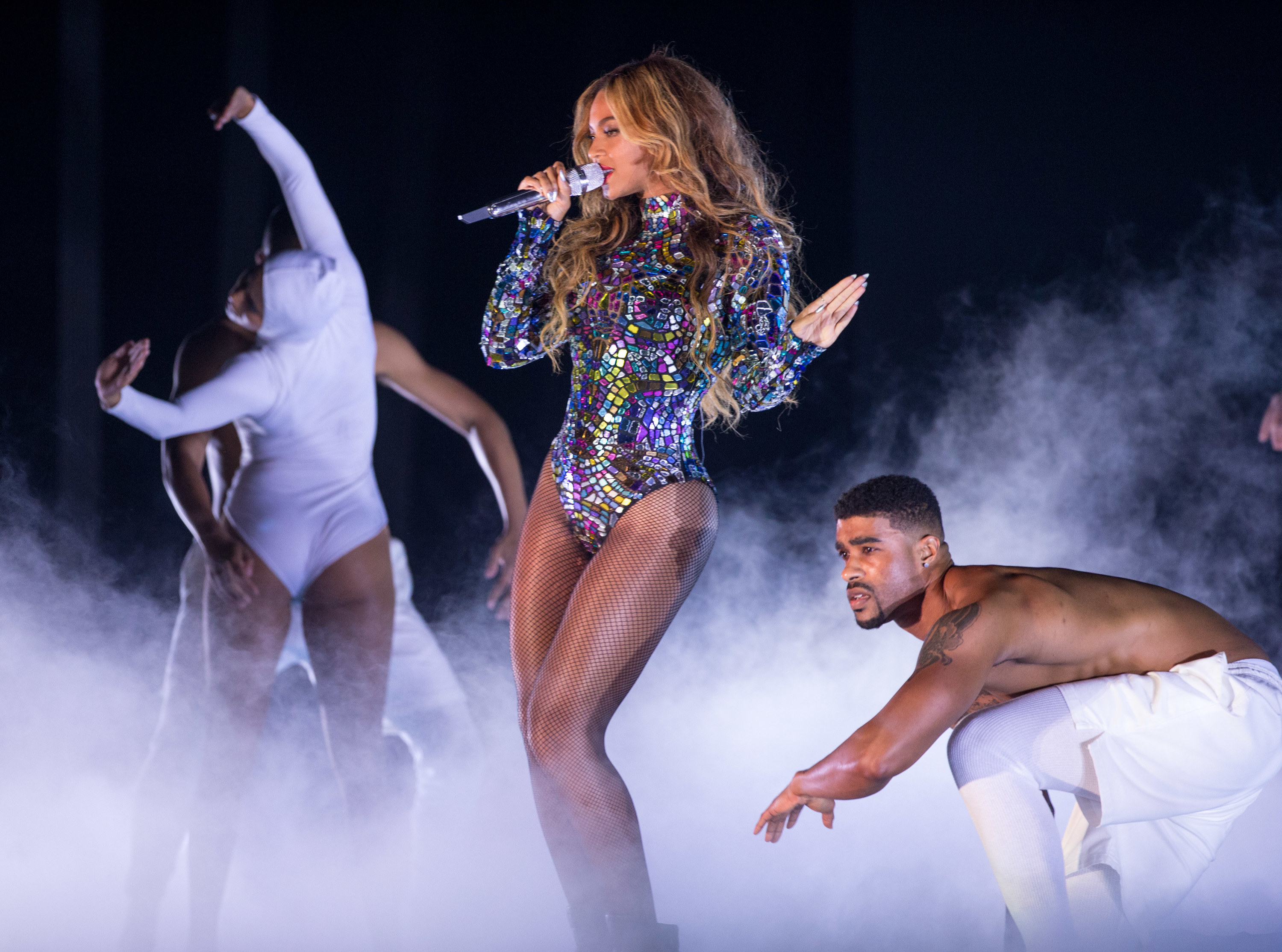 Beyoncé with dancers performing onstage with a smoke effect