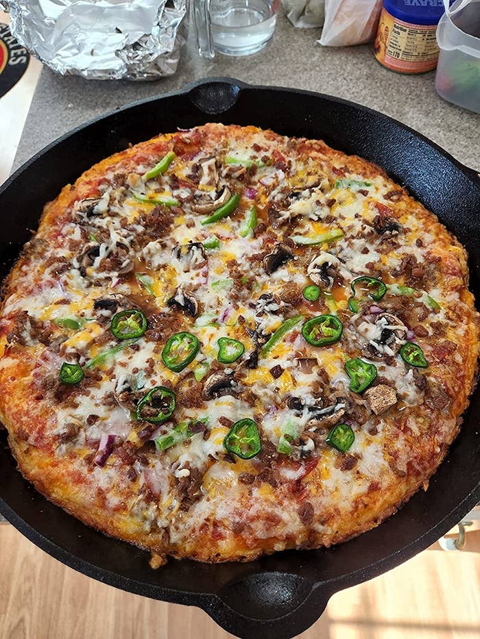 Reviewer image of pizza cooked in the cast iron skillet