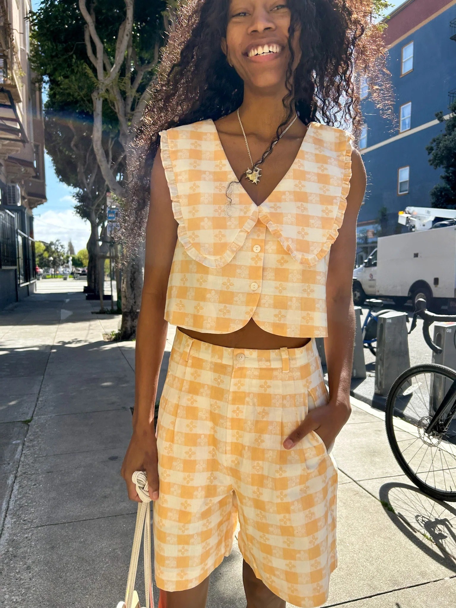 model in gingham shorts and cropped oversized collar sleeveless top