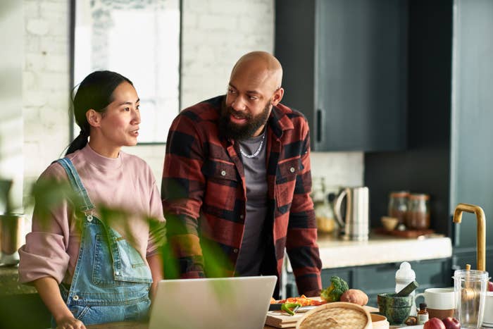 a couple talking in the kitchen