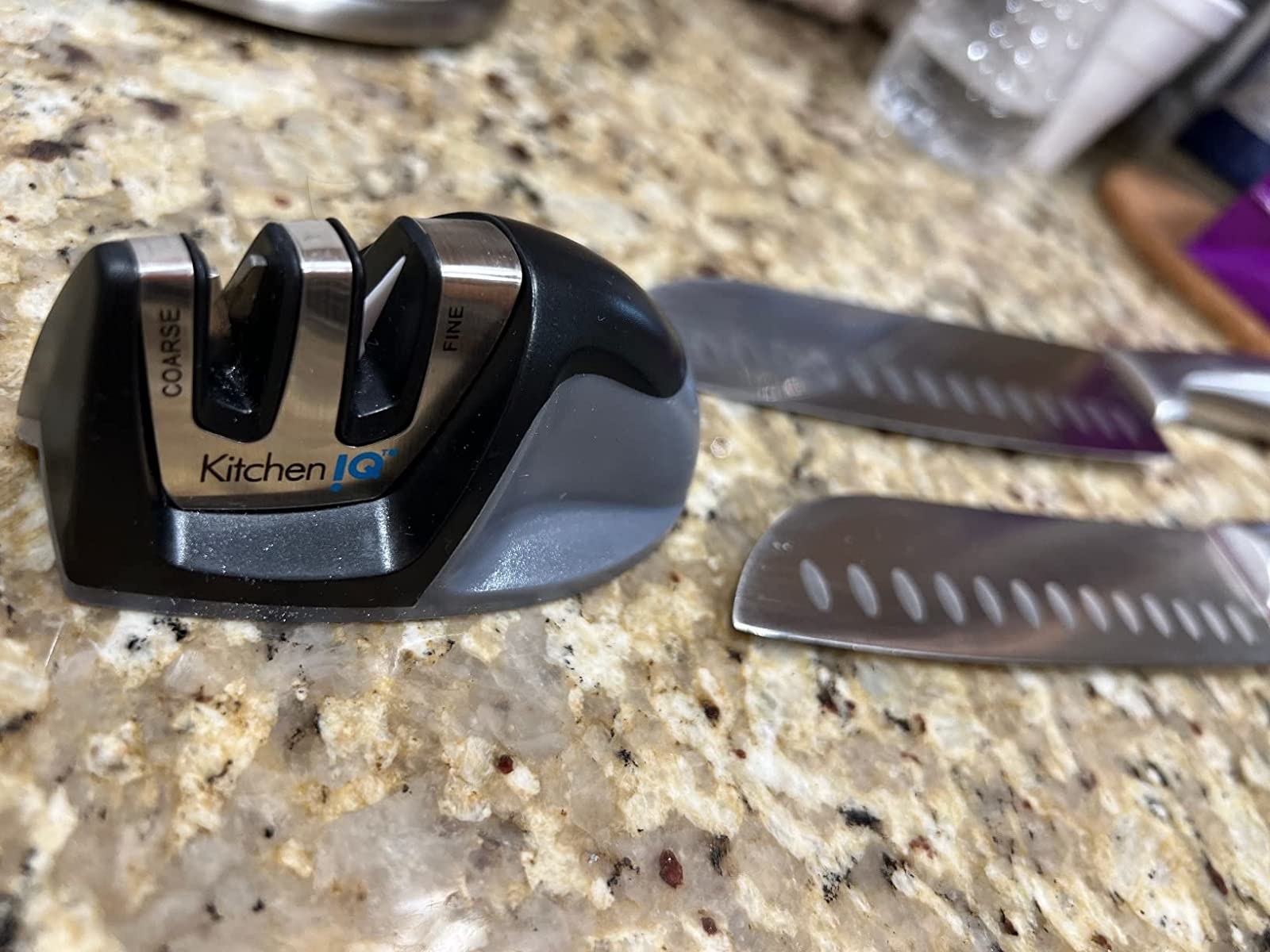 reviewer showing the knife sharpener