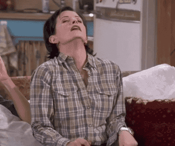 a gif of monica from friends mouthing the word seven while holding up seven fingers