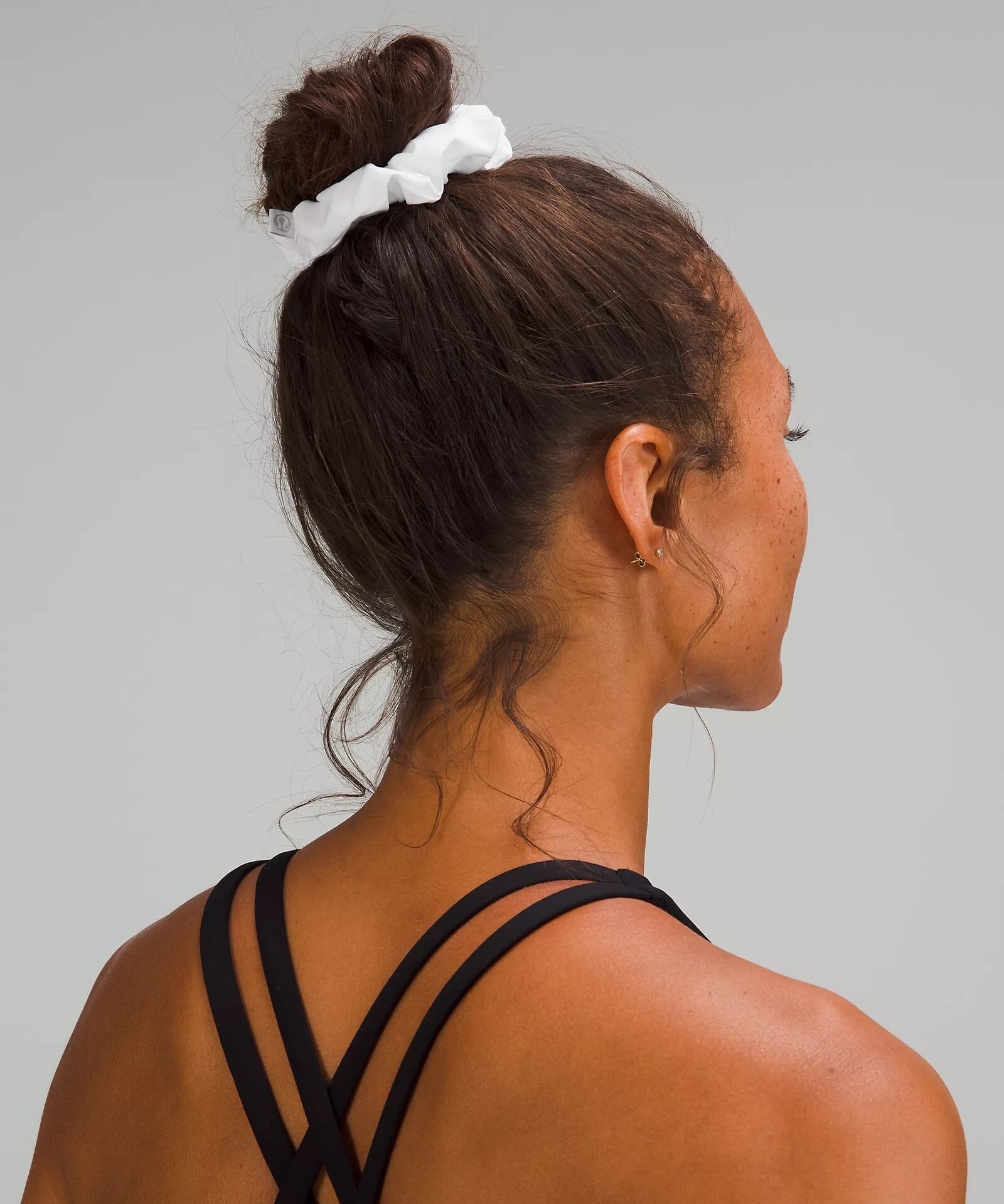 A person wearing the scrunchie in their hair