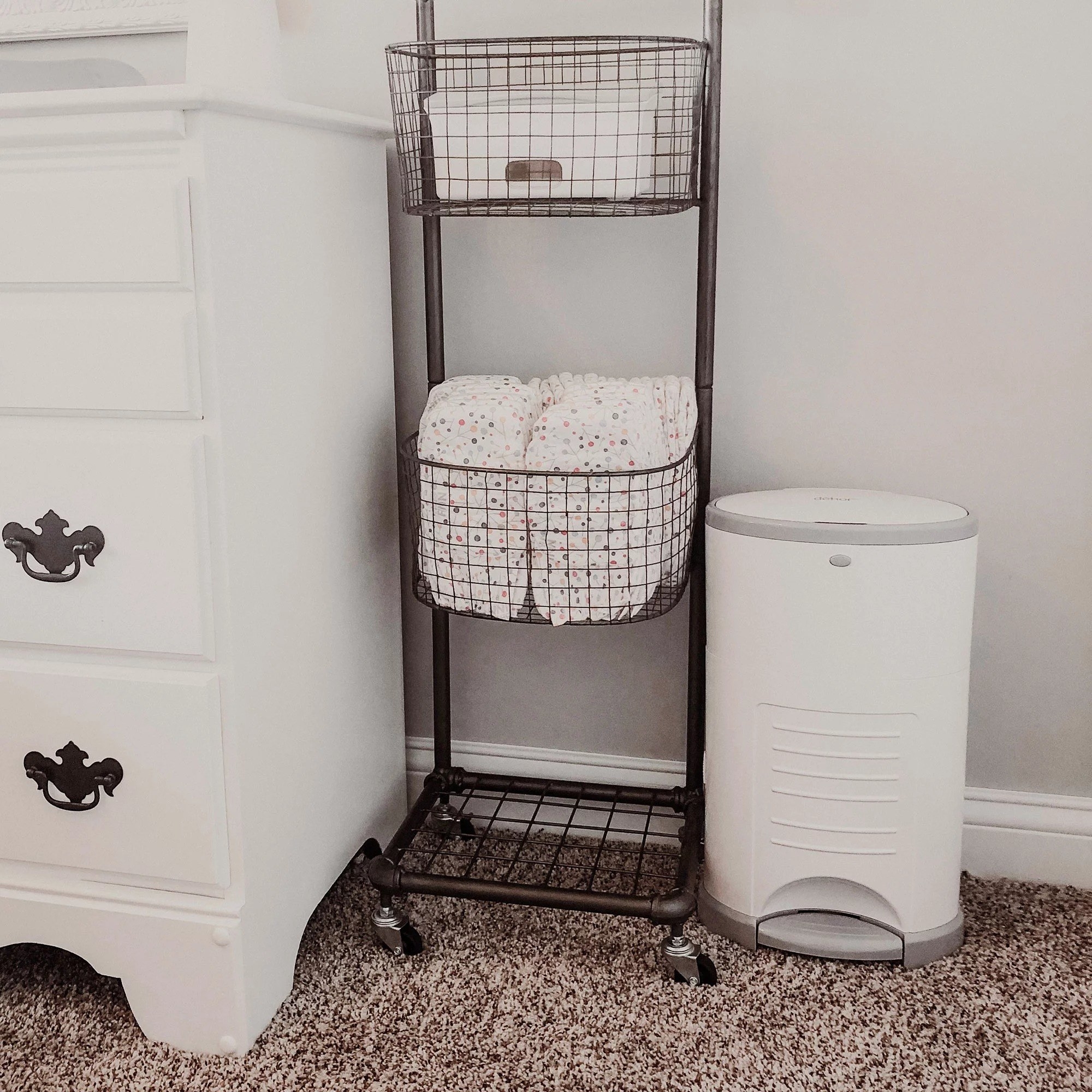 Diaper pail next to diapers