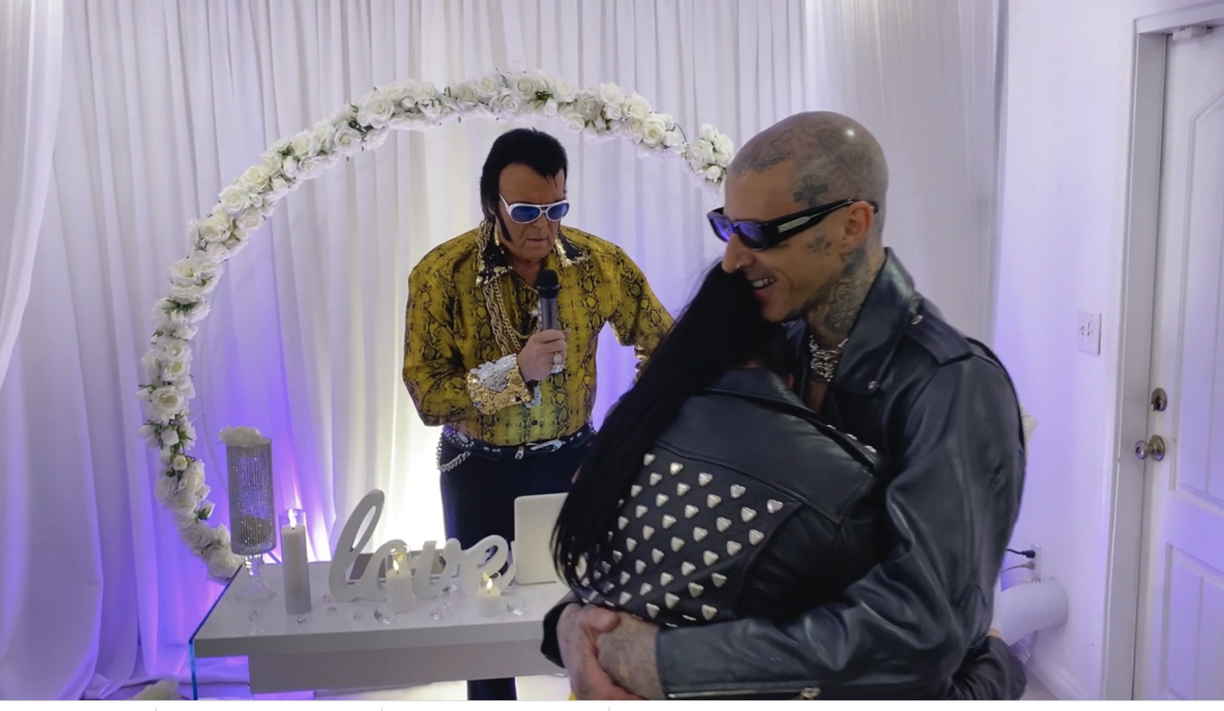Kourtney and Travis embracing in front of the officiant