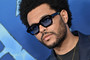 The Weeknd is seen on the blue carpet