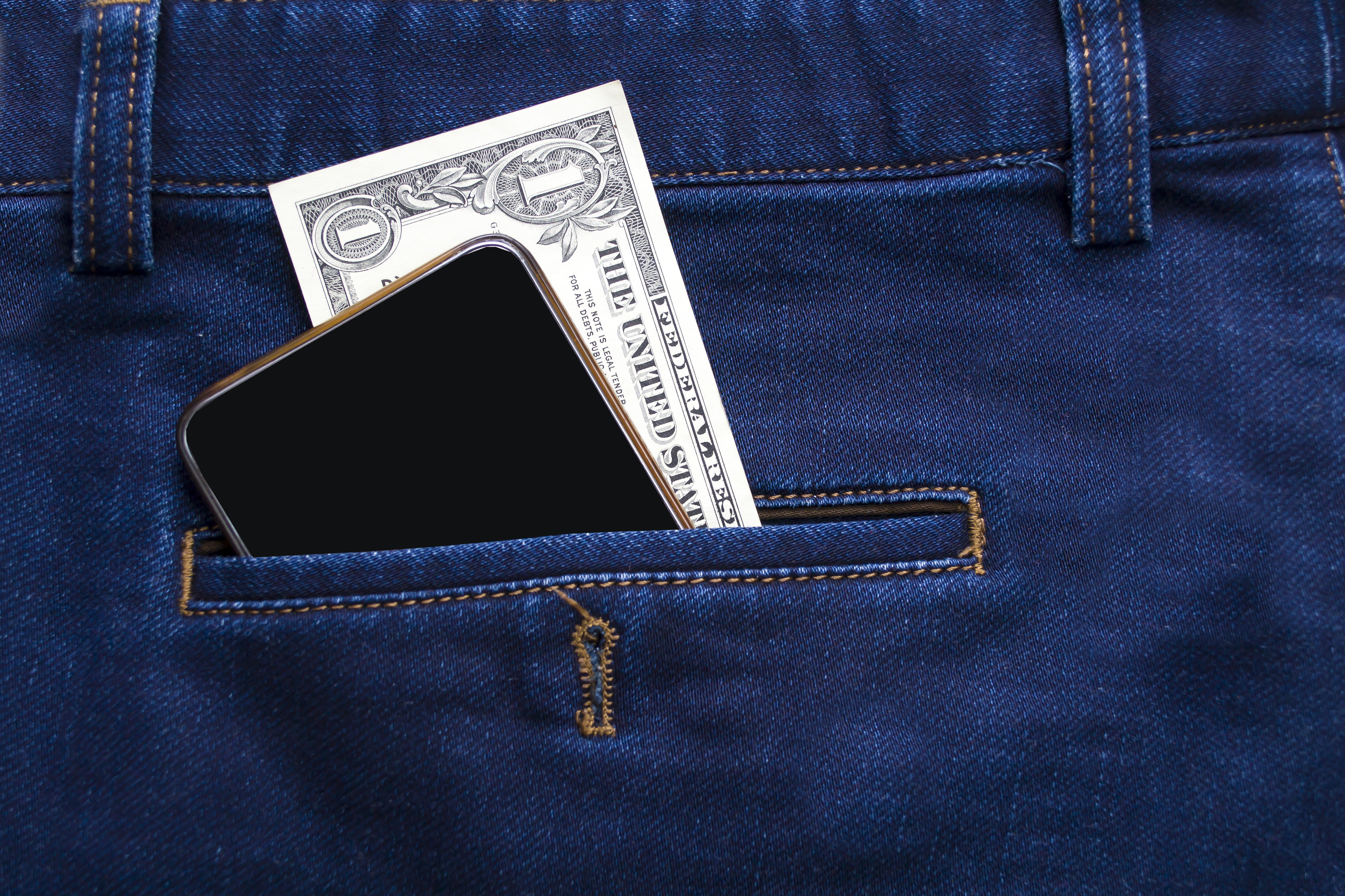 Money and phone in jeans pocket