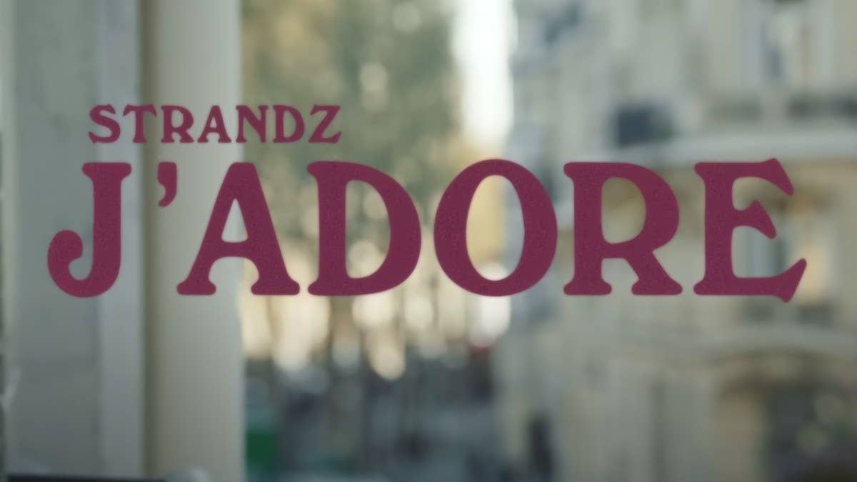 Filmed between Paris and London, the new video follows Strandz and a pal on their missions to keep up with a woman whose tastes reach beyond expensive.