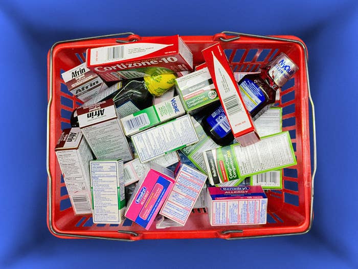 A shopping basket filled to the top with over-the-counter drugs