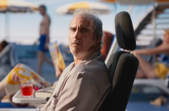 Joaquin Phoenix as Beau sitting on a cruise ship deck in pajamas