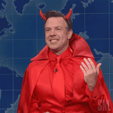 Man in a devil costume shrugging