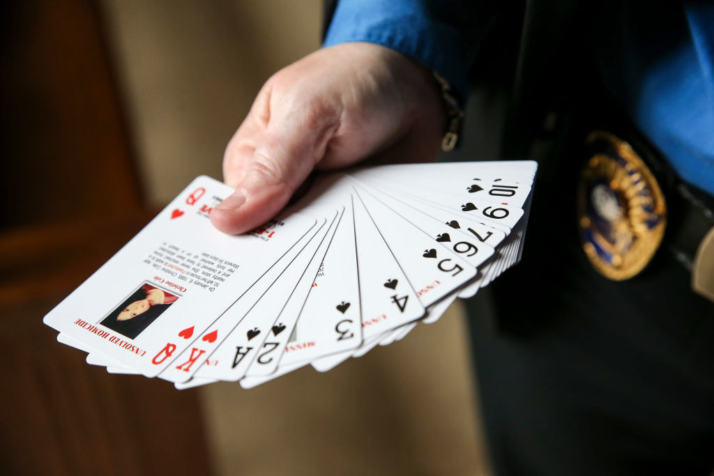 A hand holding a deck of playing cards