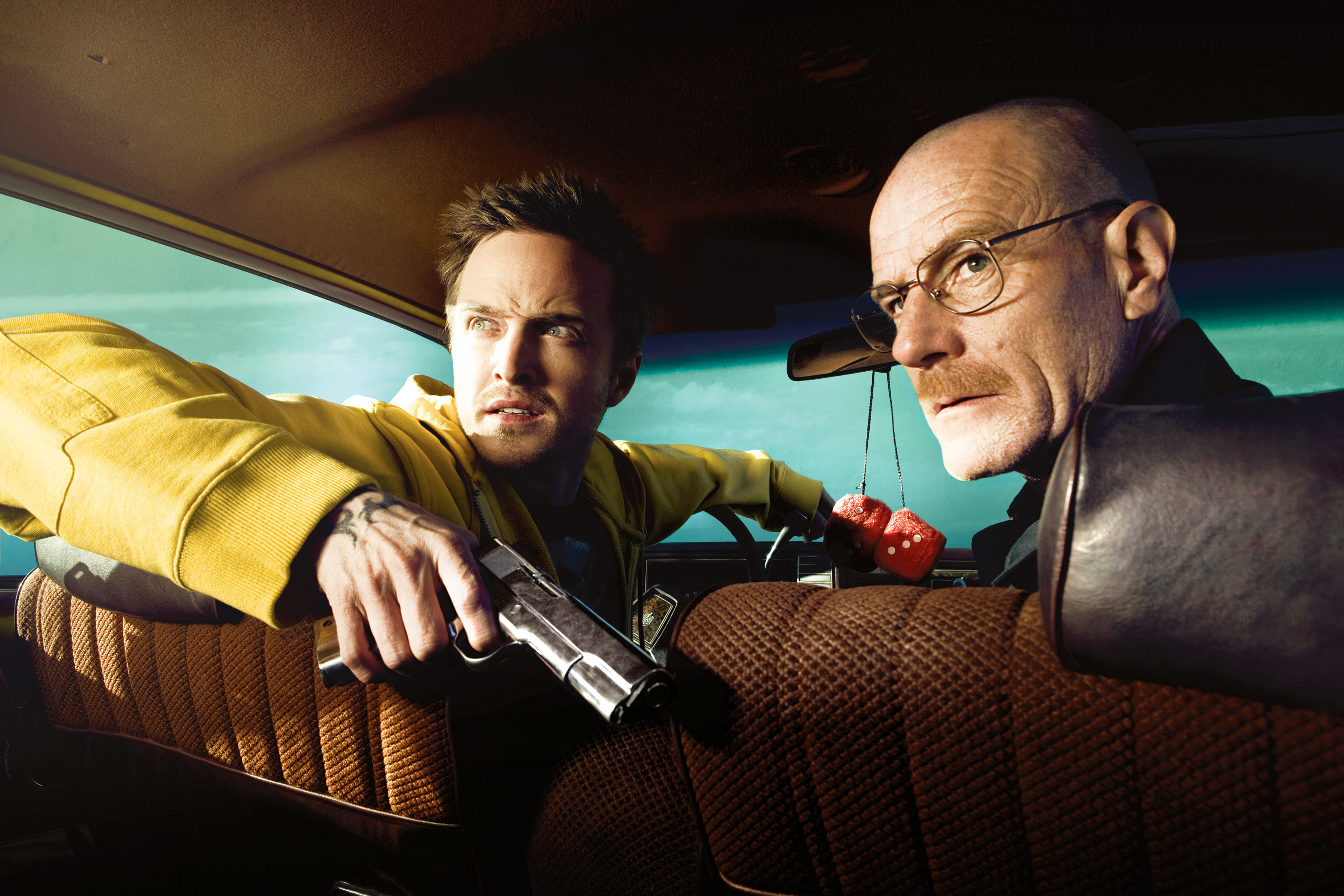 two characters in a car one holding a gun