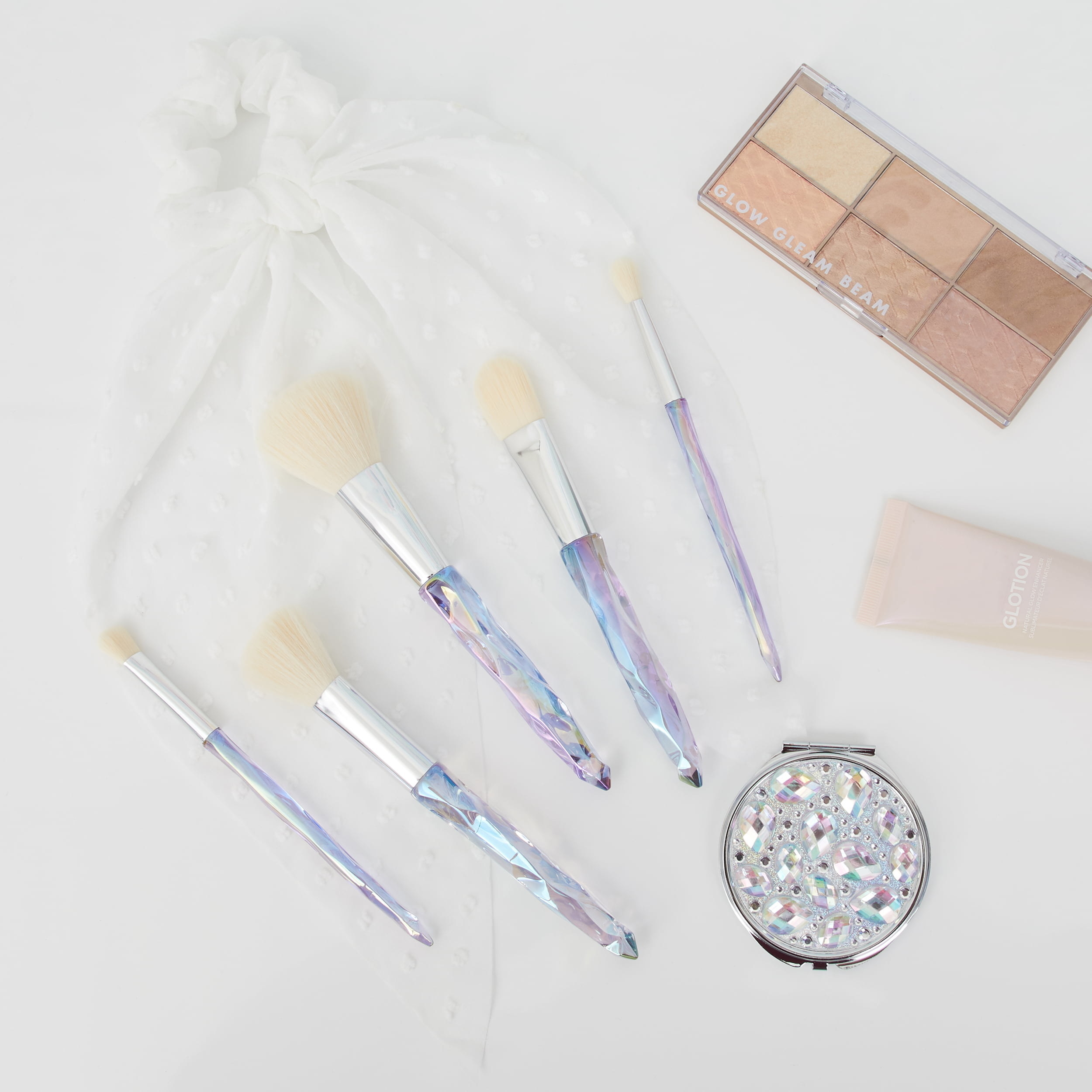 the makeup brush and mirror set that has pastel iridescent colors