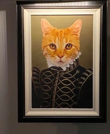 The overhead light above a portrait style painting of a cat