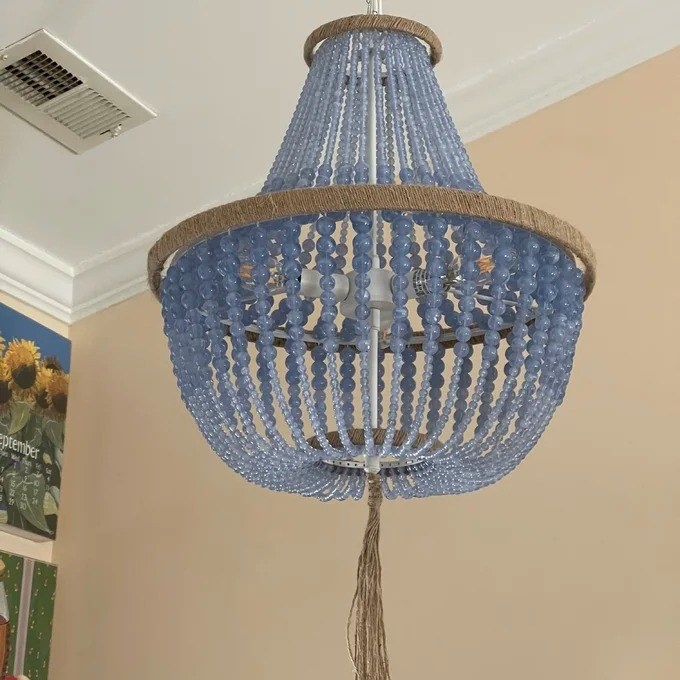A reviewer&#x27;s pic of the light blue beaded chandelier