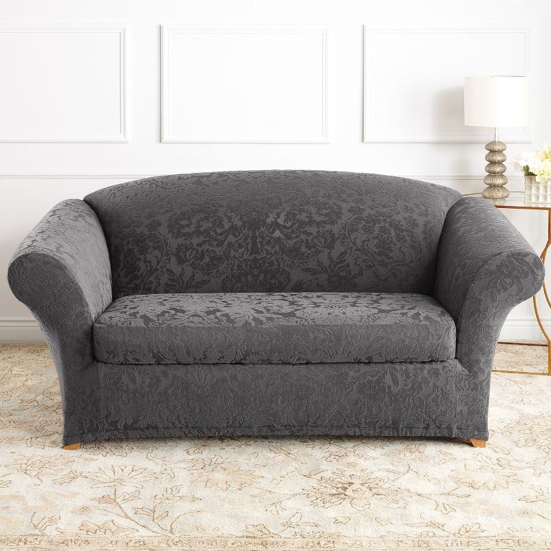a gray loveseat cover in a living room