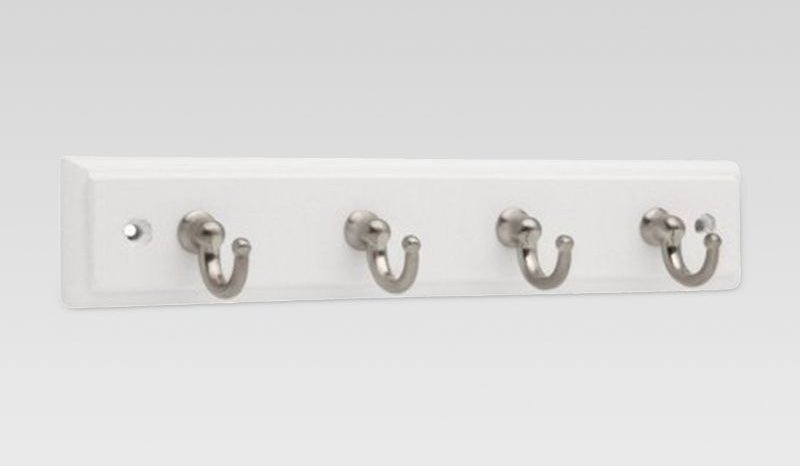 a gray and white key rack with silver hooks