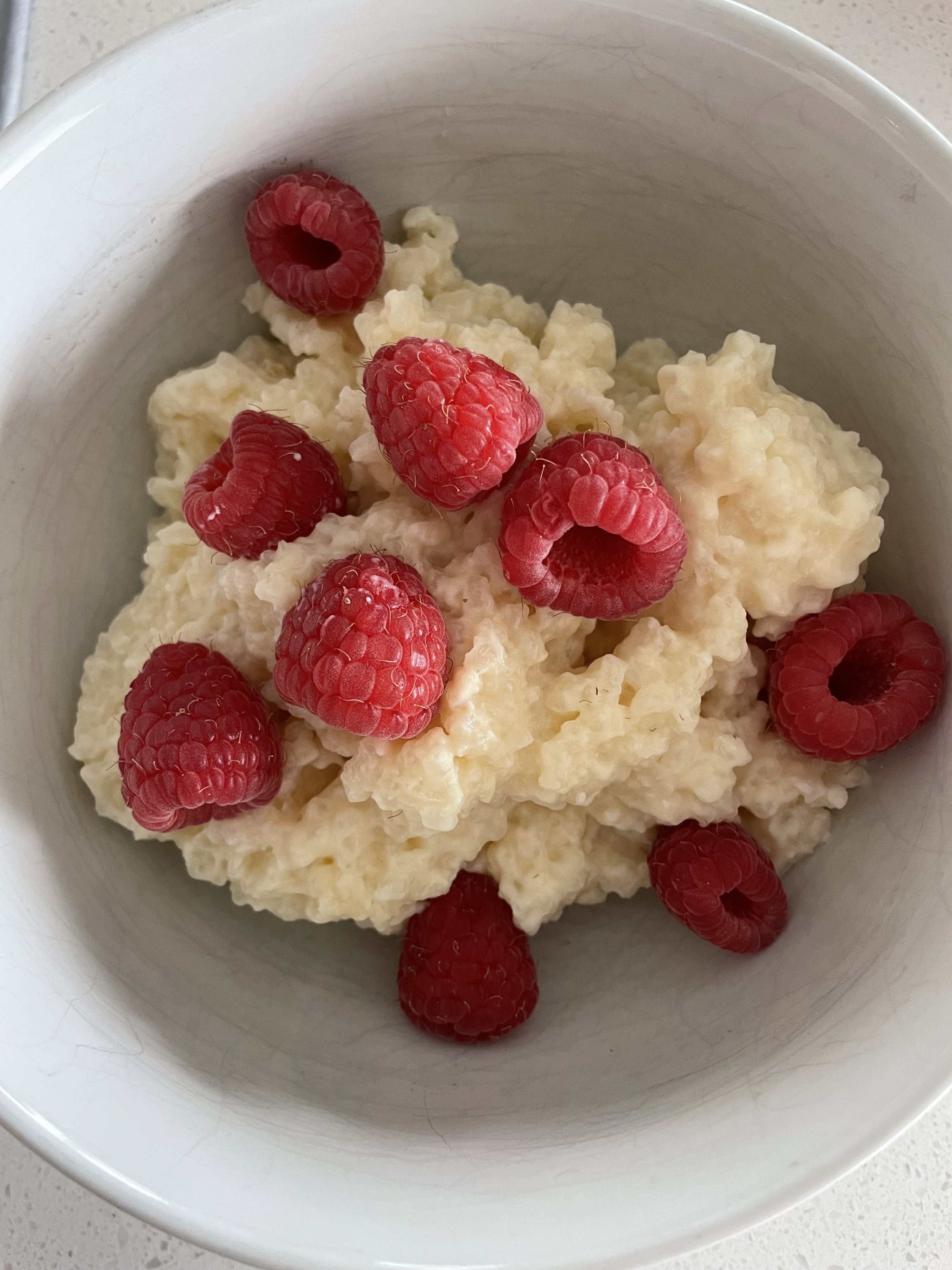 rice pudding with raspberries in a bowl