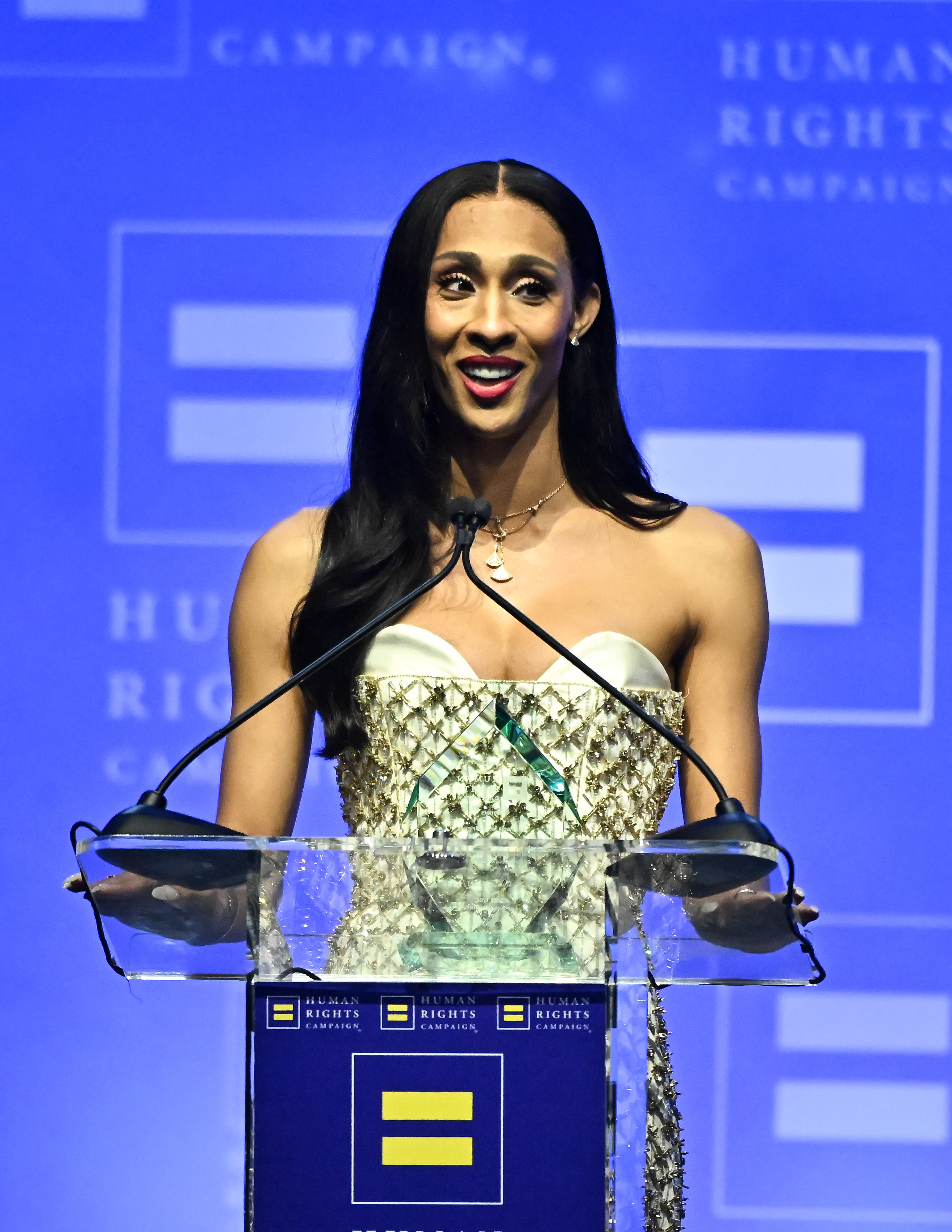 Michaela speaking at a podium