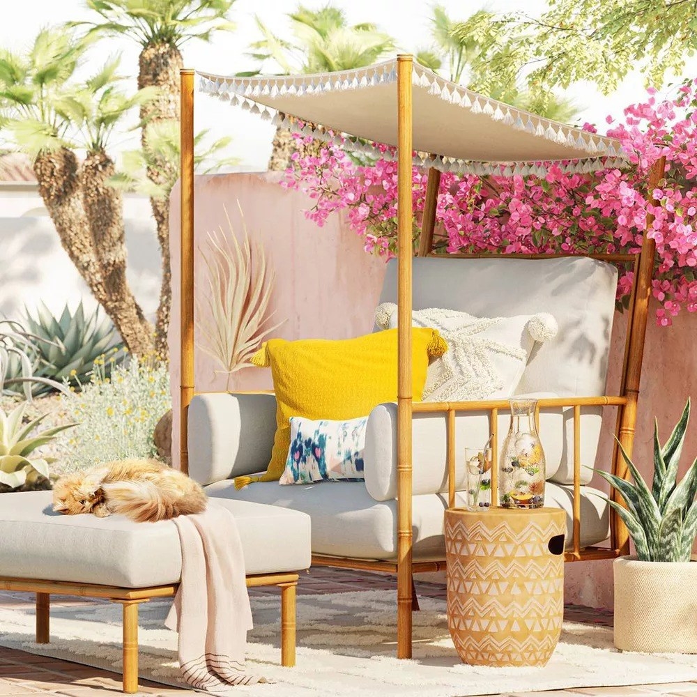 the white chair decorated with pillows on a patio