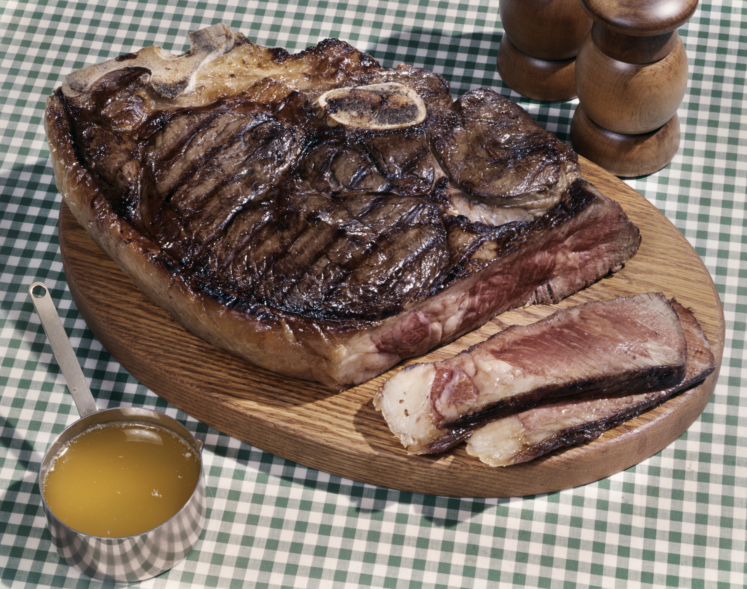 A steak on a wooden plate