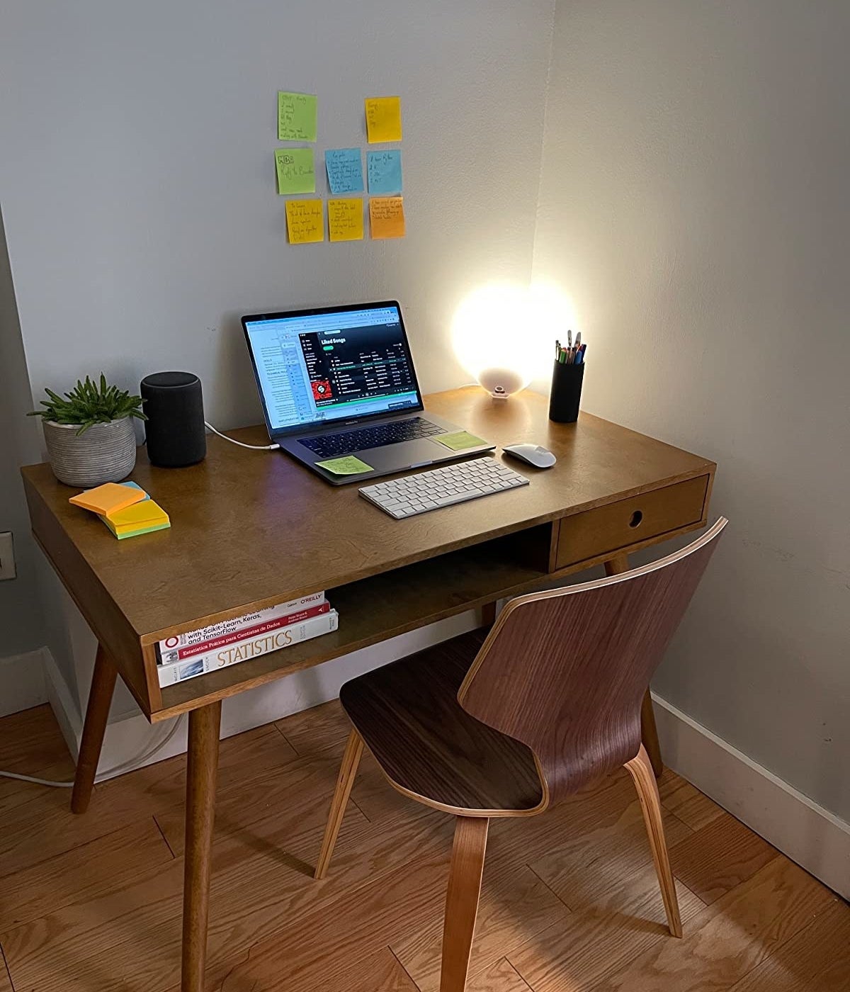 A reviewer&#x27;s photo of the writing desk with their laptop on it