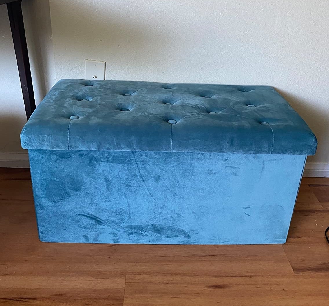 A reviewer&#x27;s photo of the large blue ottoman