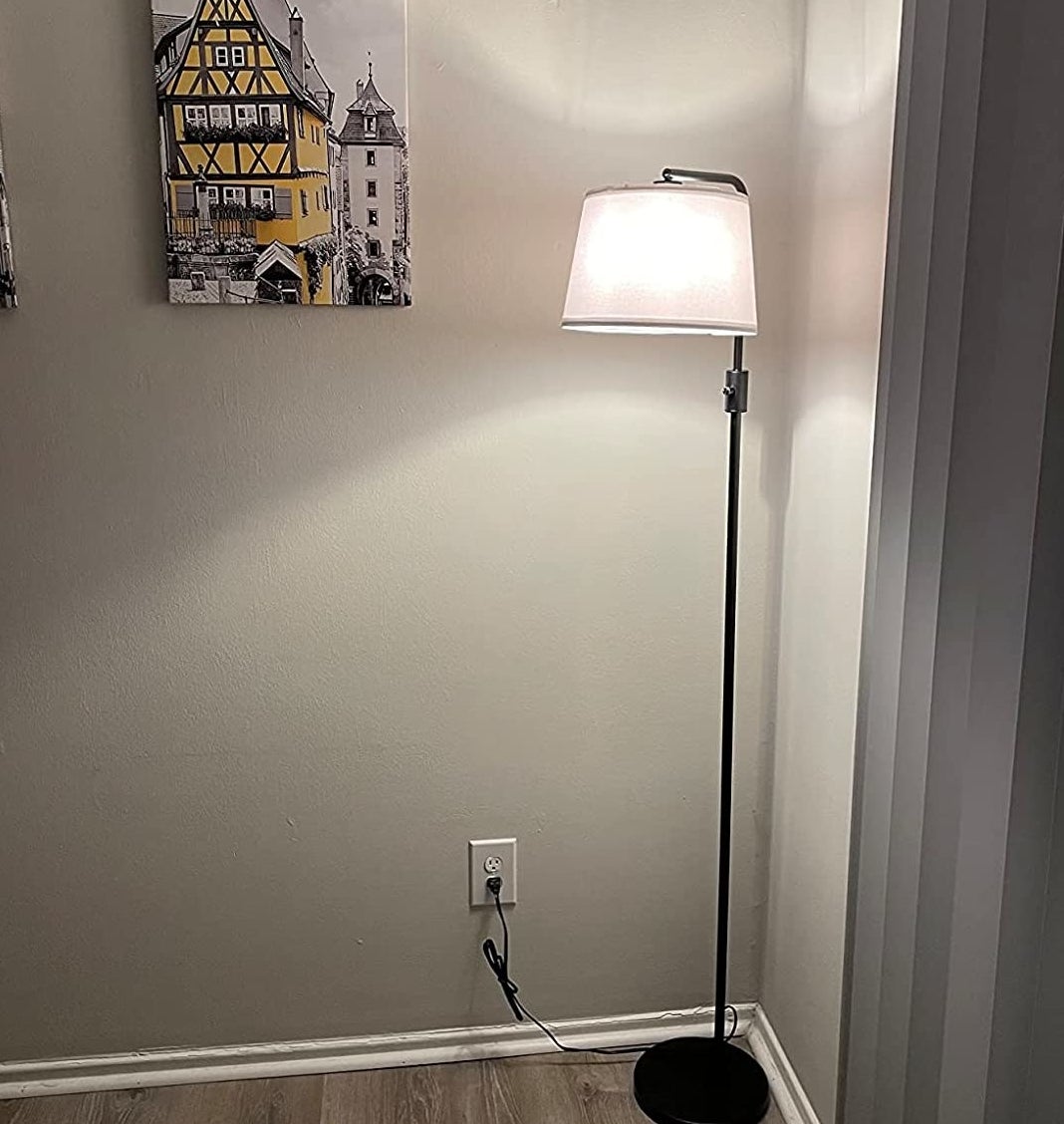 A reviewer&#x27;s photo of the floor lamp in the living room
