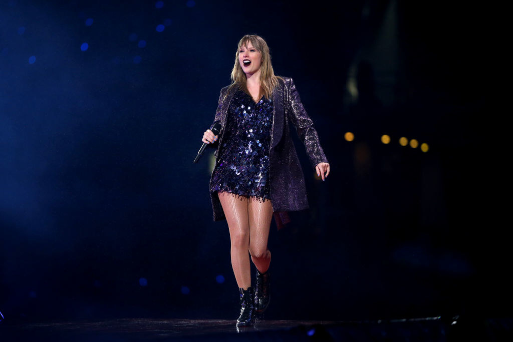 Taylor Swift in a glittery jacket and dress.