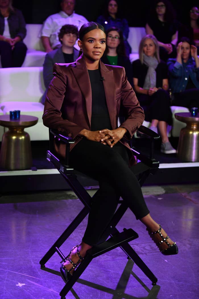 Candace sitting in a director&#x27;s chair on a set with a studio audience