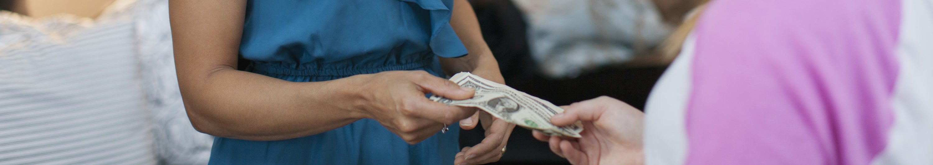 Someone handing someone else cash