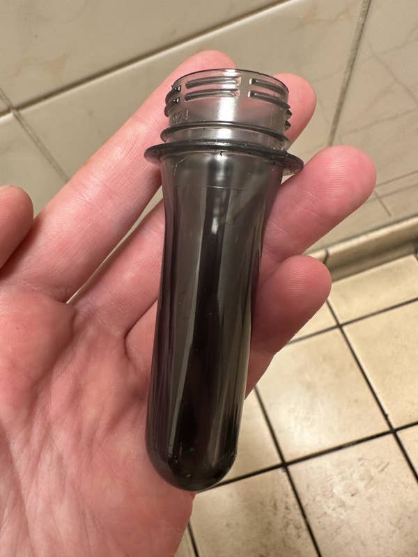 Someone holding a small, plastic sheath