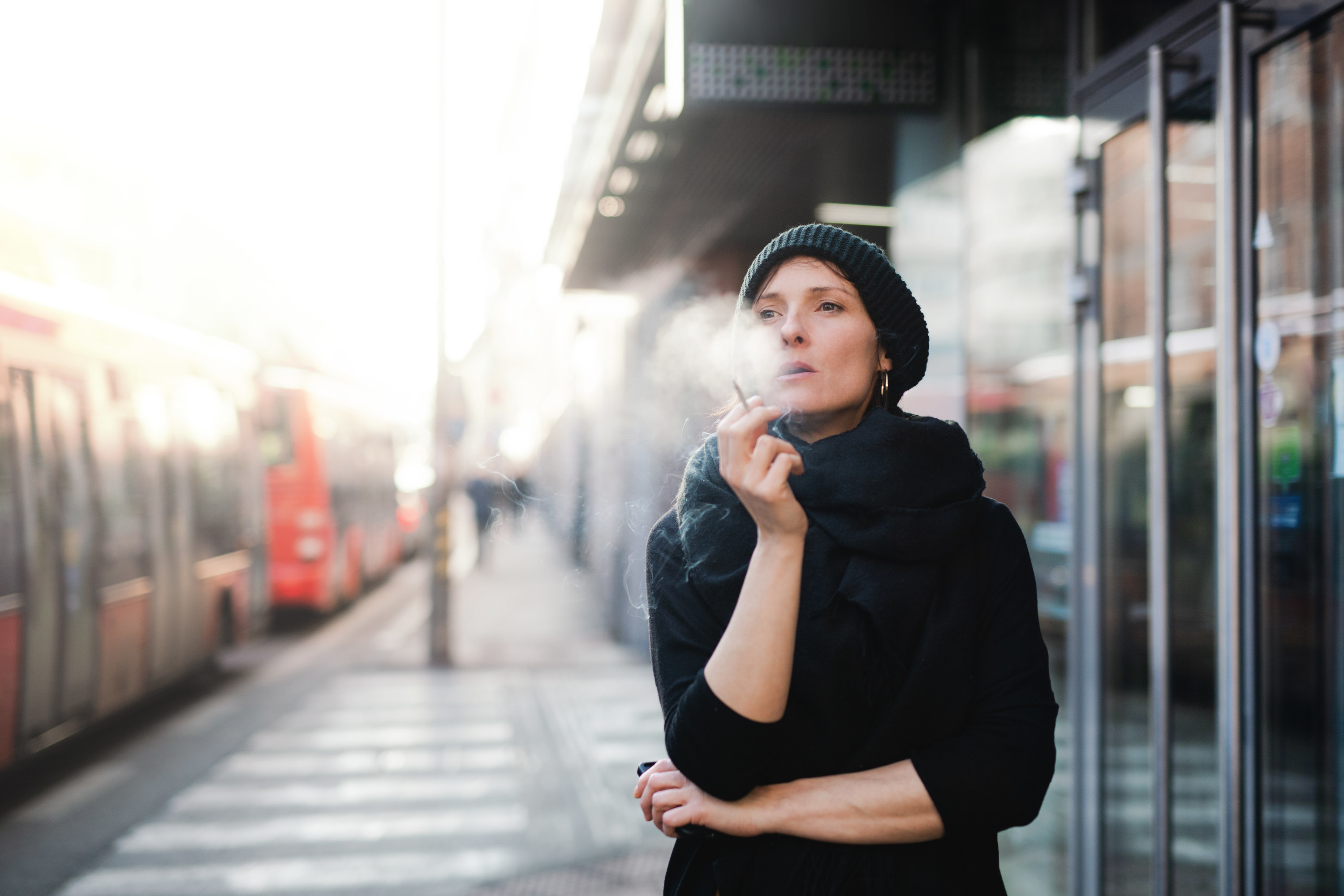 A woman smoking outside of a building