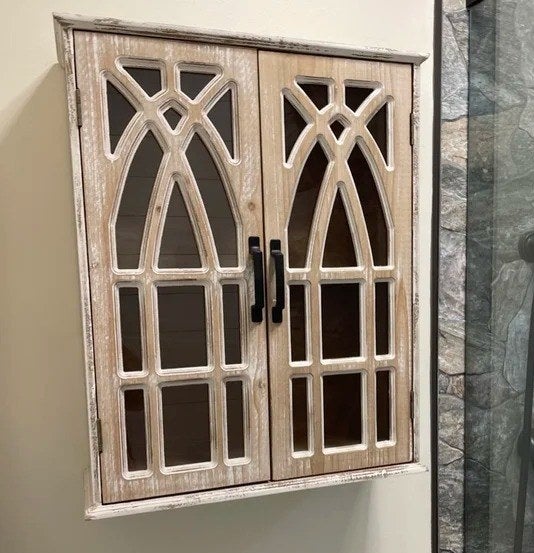 A reviewer photo of the cabinet with intricate doors in a bathroom
