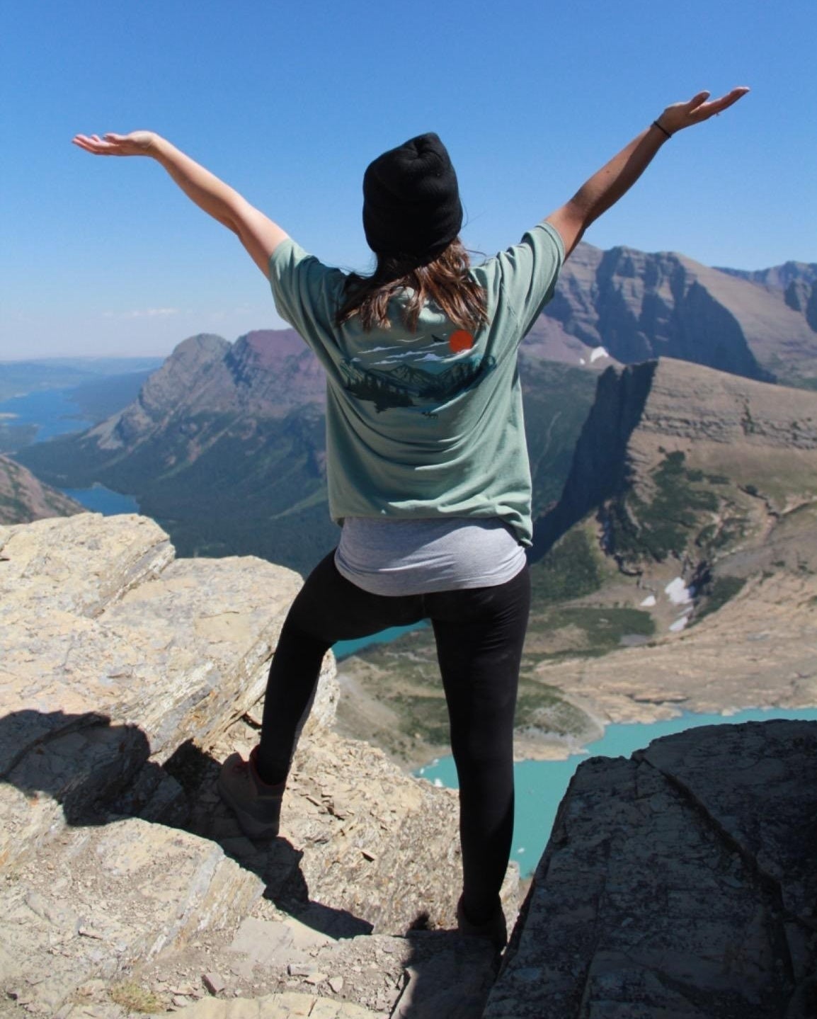 a reviewer wearing the leggings on a hike in the mountains