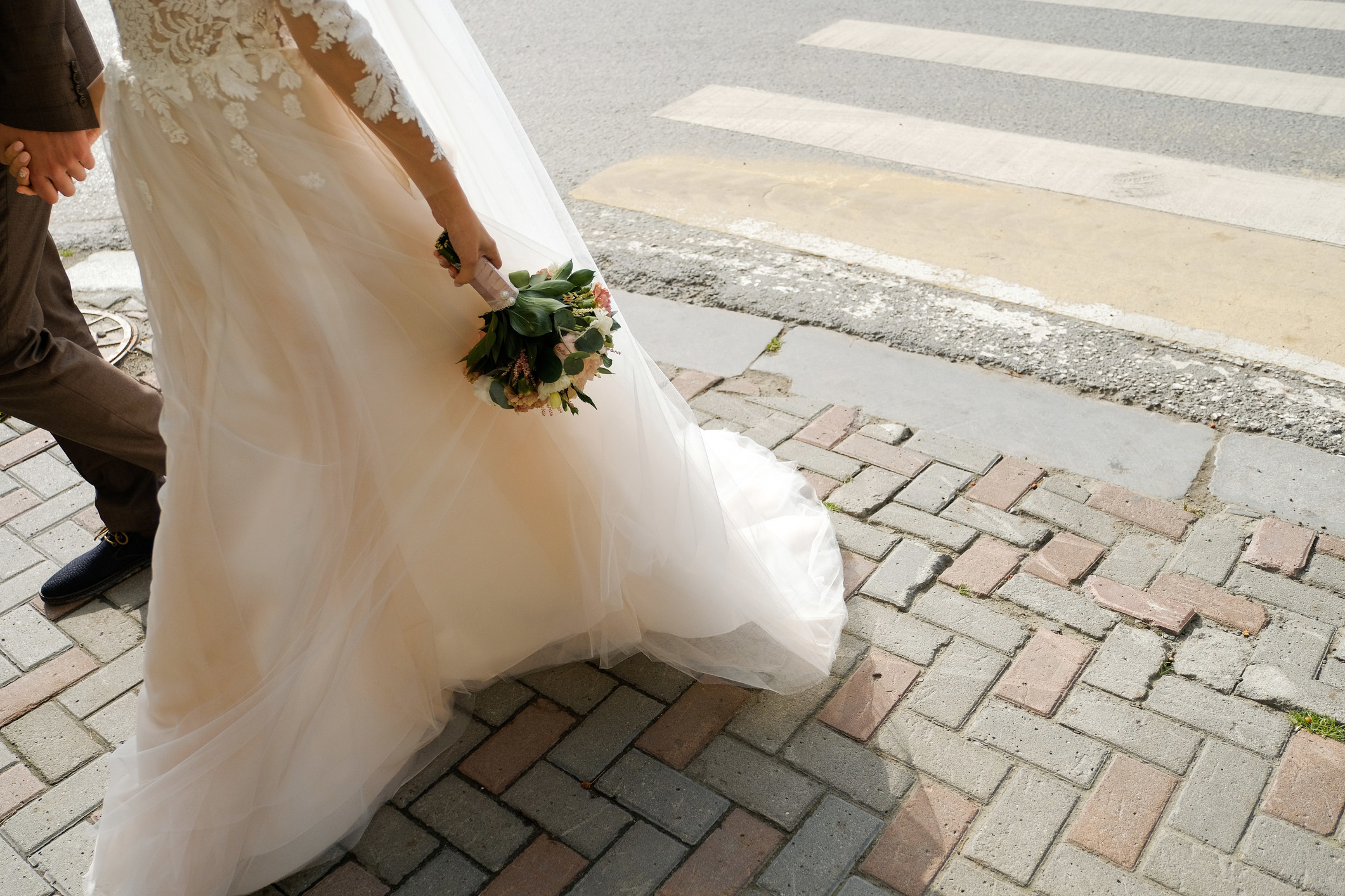 person in a wedding dress walking outside