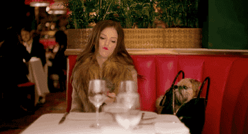 Anna Kendrick being stood up at restaurant and placing phone angrily on the seat