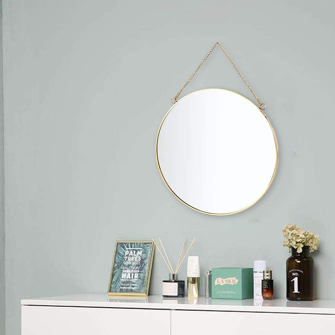 The mirror is hung above a dresser in a bedroom