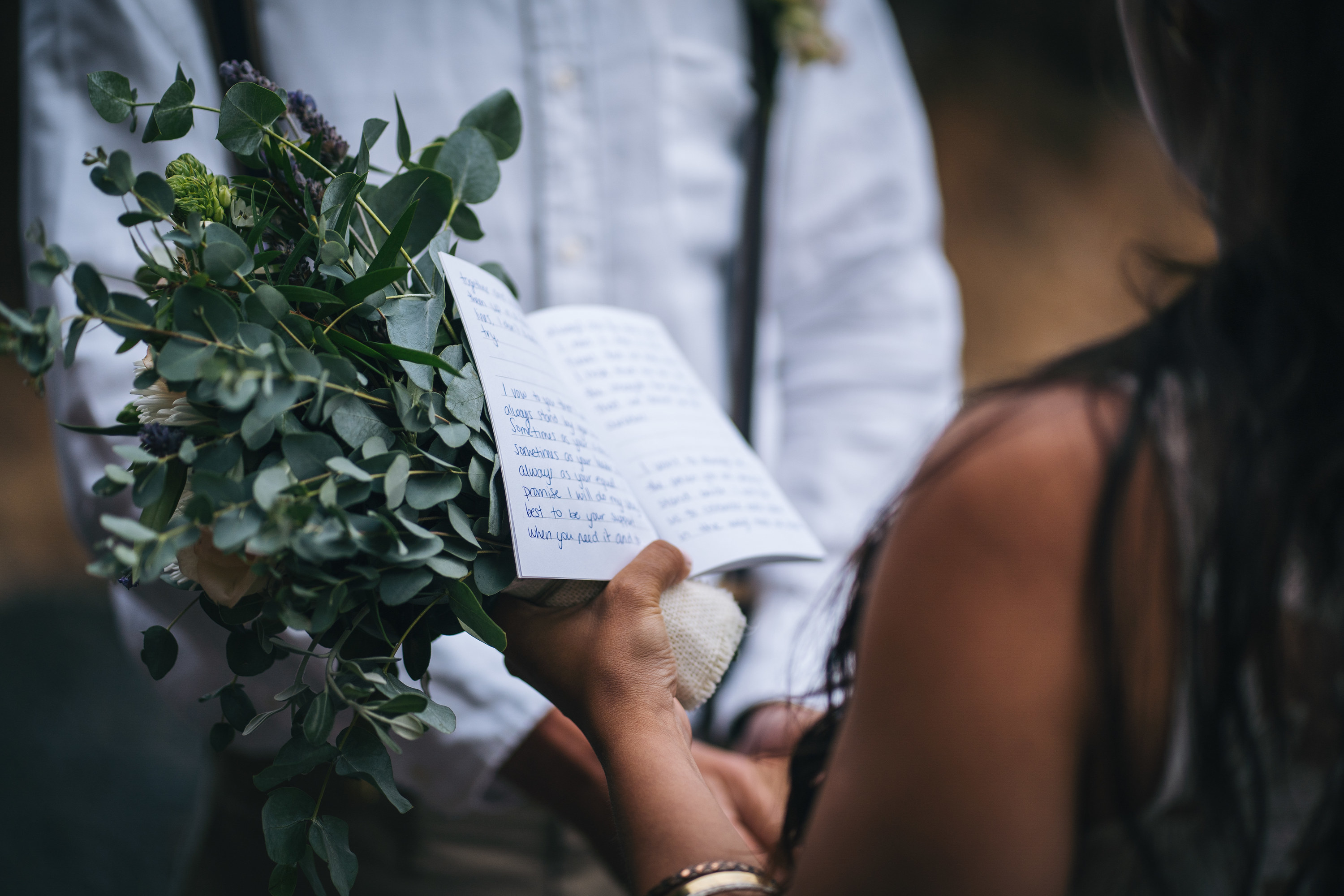 bride reading vows from booklet