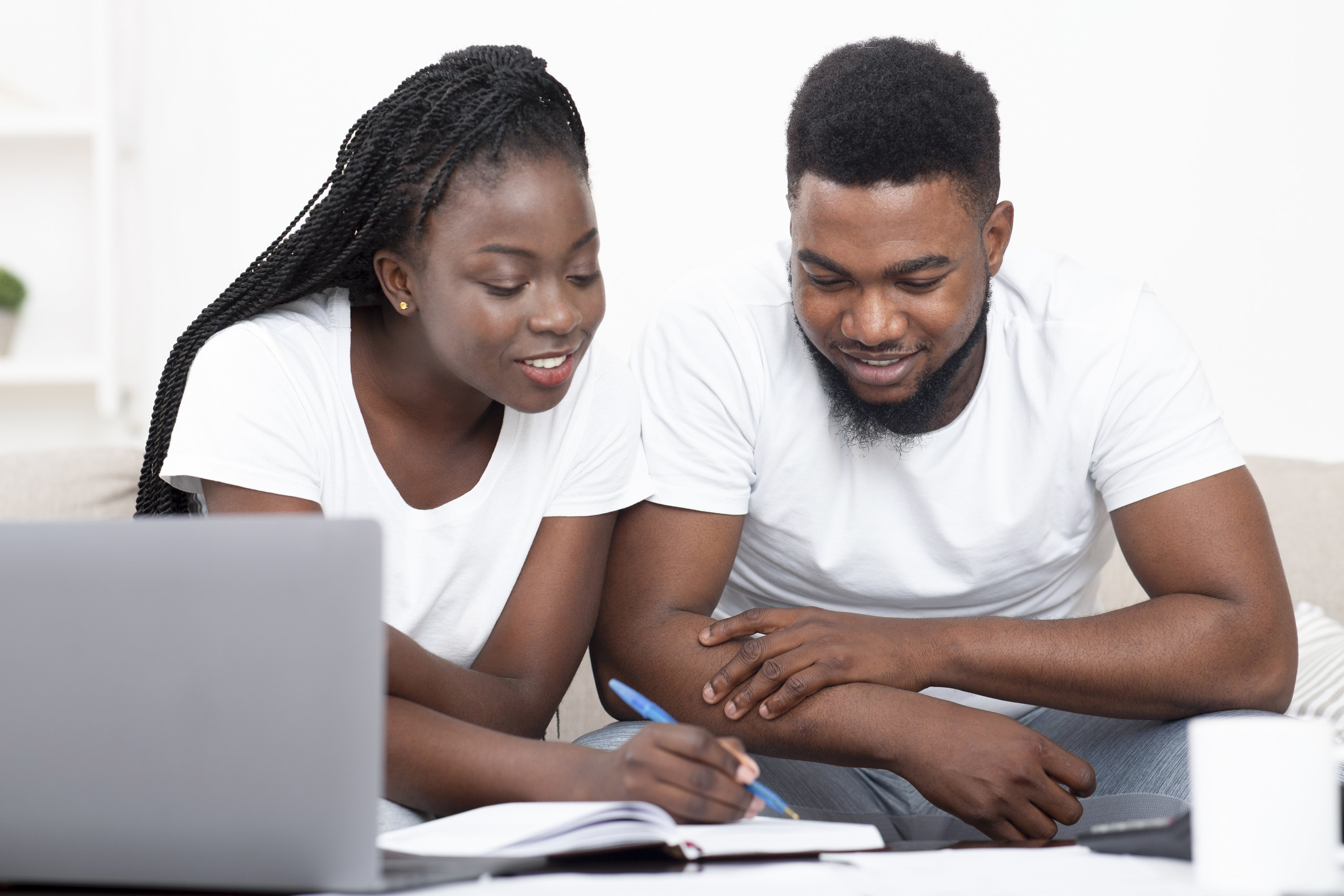 couple looking over guest list in a notebook