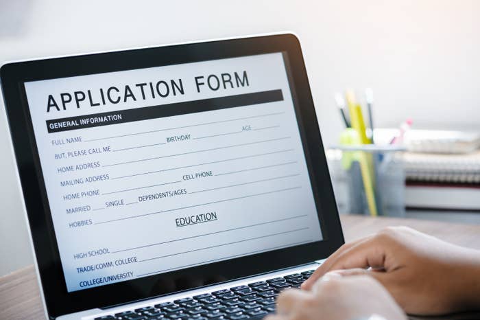 A person fills out a job application on their laptop