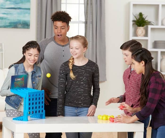 kids playing with Connect 4 Shots game