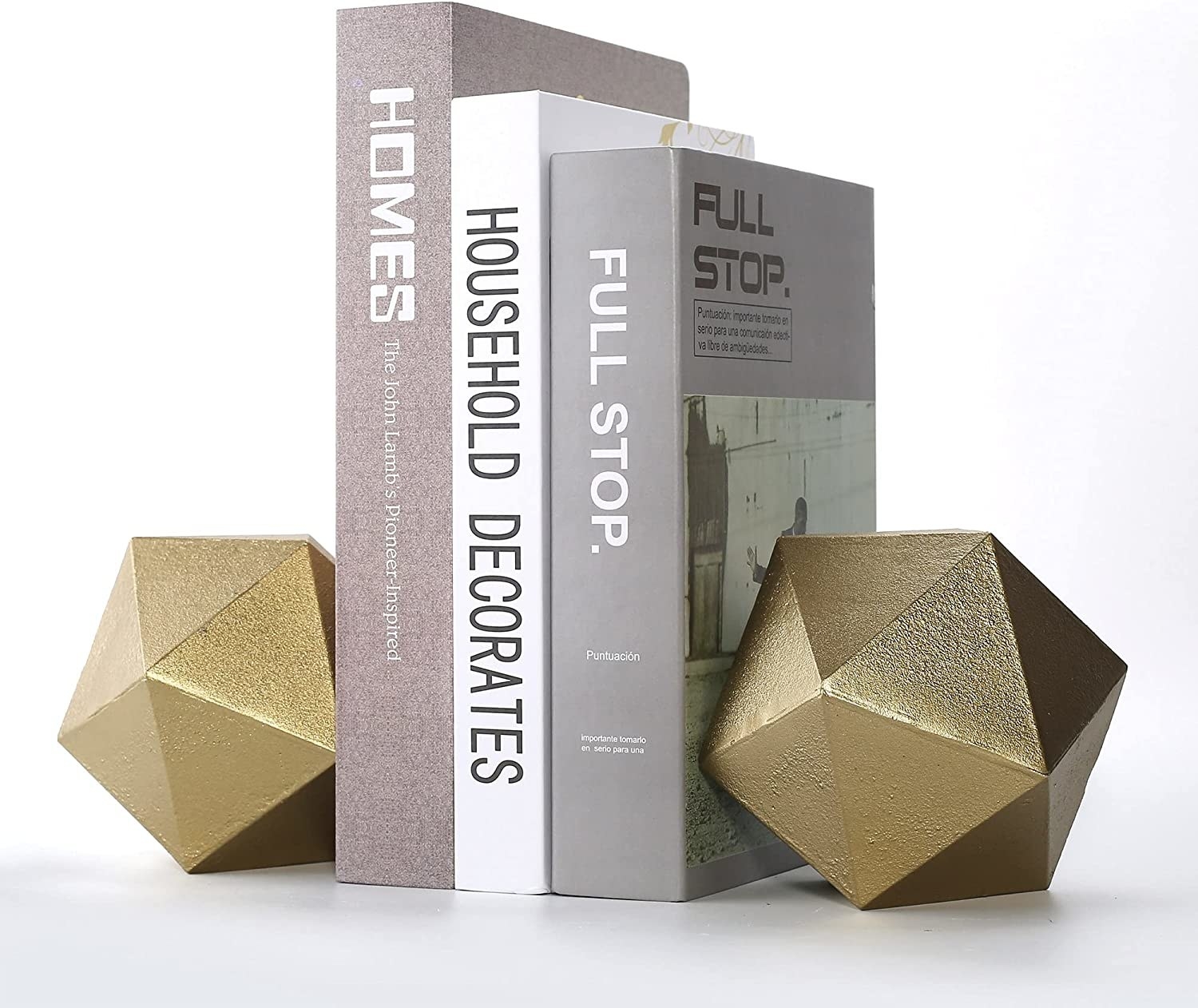 The gold geometric bookends are shown holding three books together