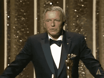 Frank Sinatra blows a kiss to the audience from the Academy Awards stage.