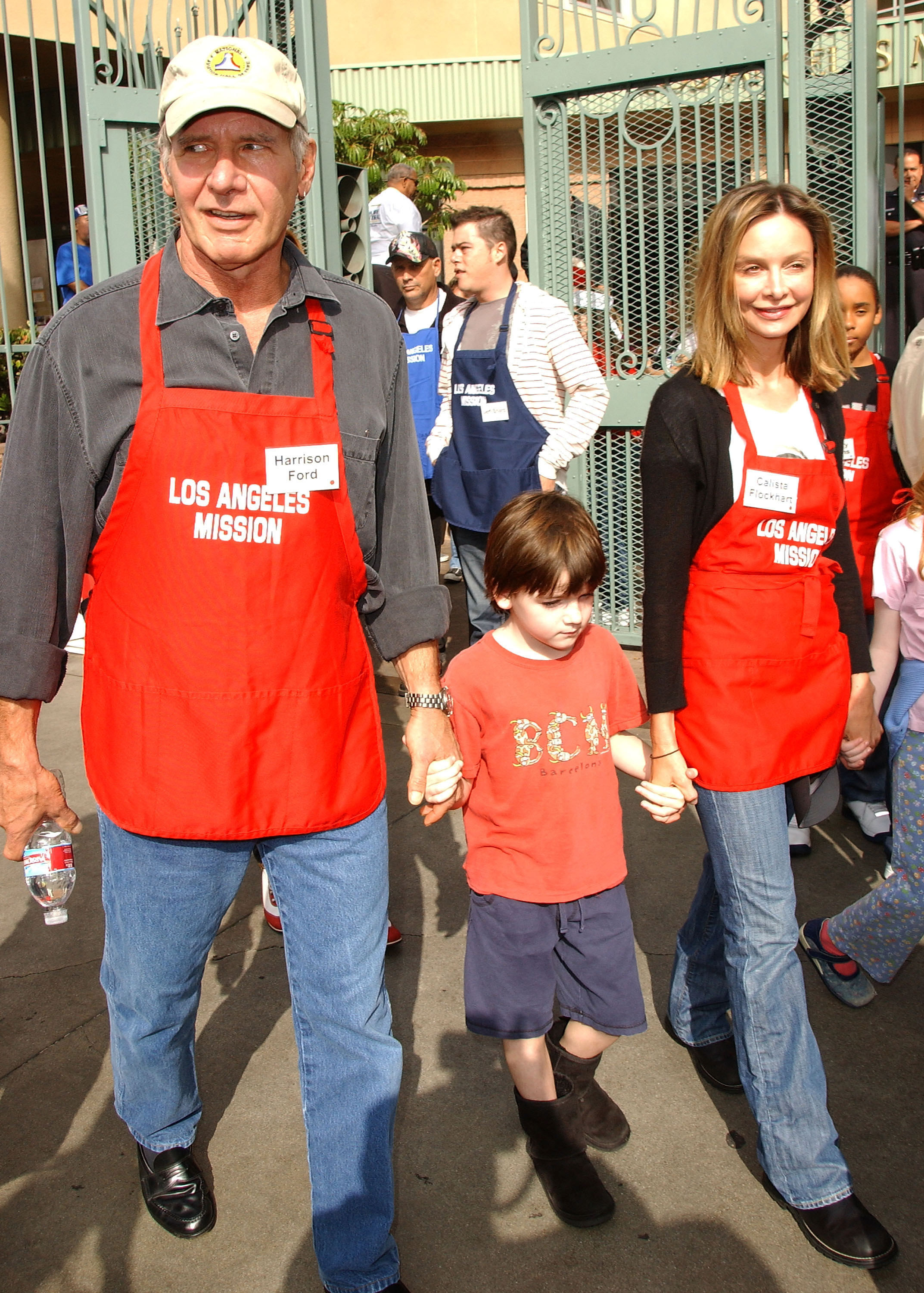 Harrison Ford and Calista Flockhart with son Liam participate in serving Thanksgiving dinner to the Skid Row homeless at the Los Angeles Mission