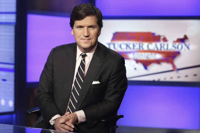 tucker carlson in a suit in a tv studio