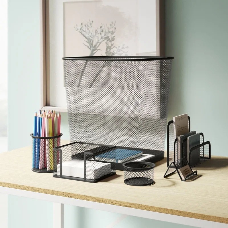 the black wire desk organizer set with a wastebasket, filer, stick pad holder, business card tray, pencil cup filled with colorful pencils, and a paperclip holder